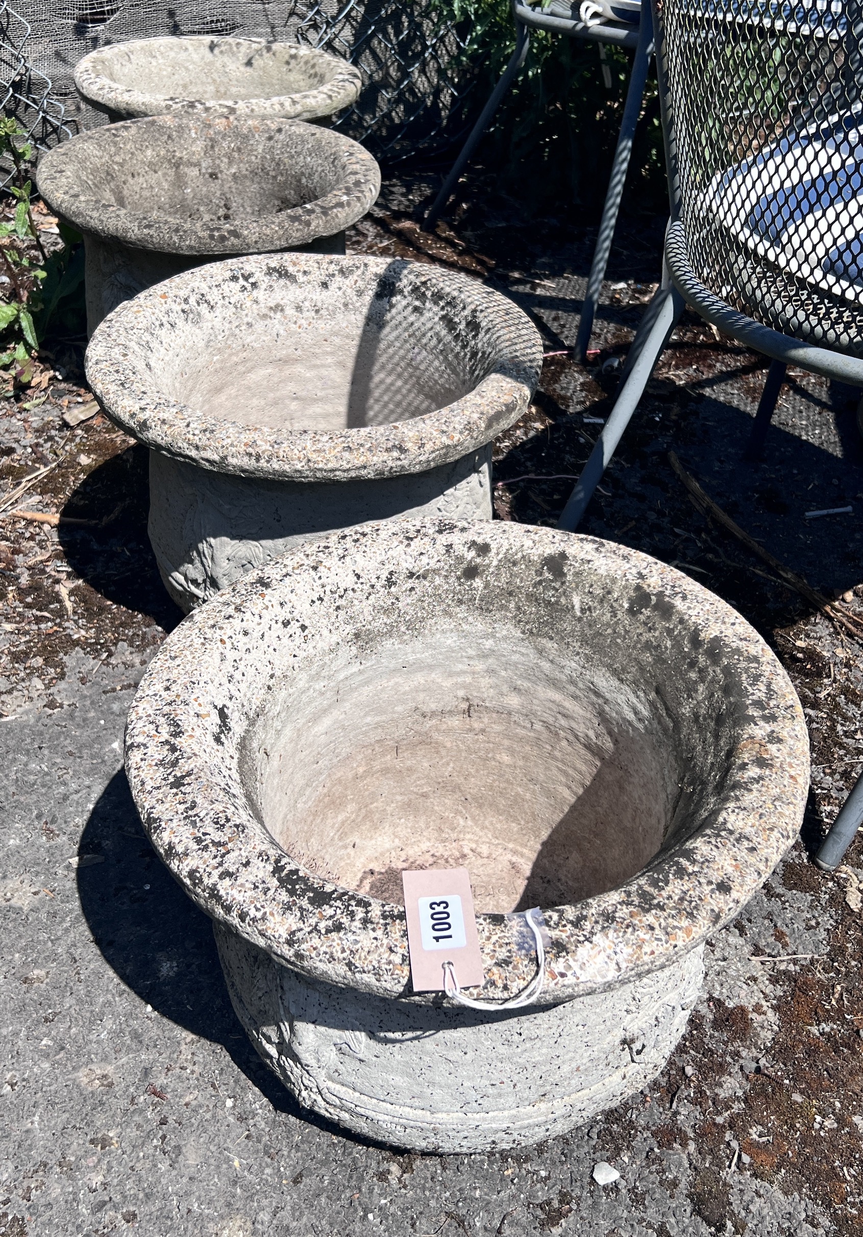 A set of four circular reconstituted stone garden planters, diameter 41cm, height 28cm